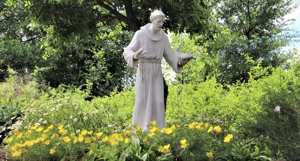 A quiet prayer path winding through the cemetery gardens